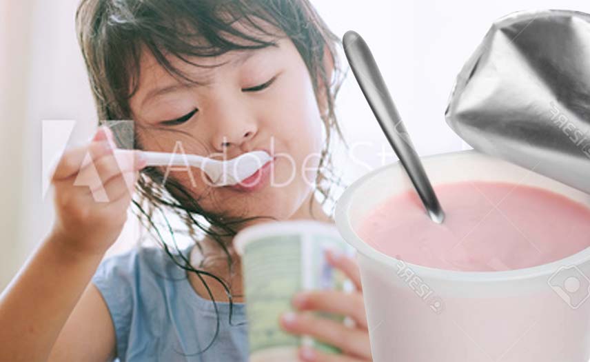 young-asian-girl-eating-yogurt-with-spoon